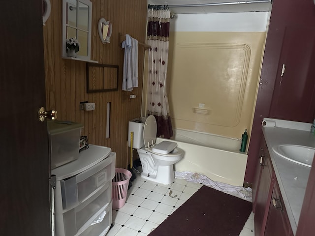 bathroom with shower / tub combo, wooden walls, toilet, tile patterned floors, and vanity