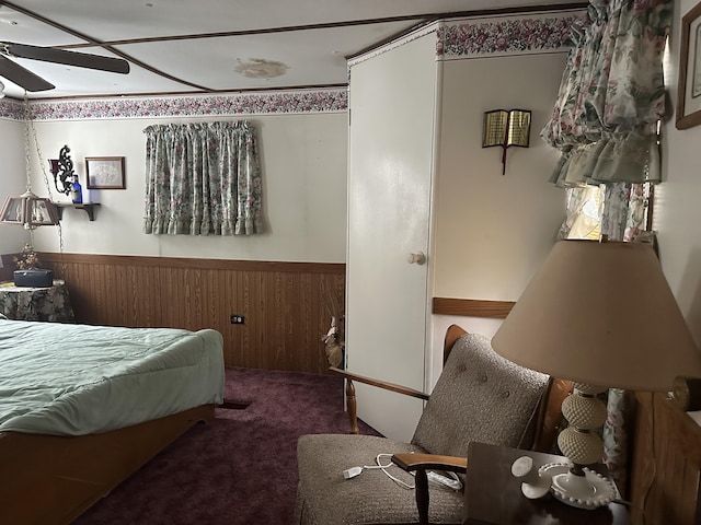 bedroom with carpet and a wainscoted wall