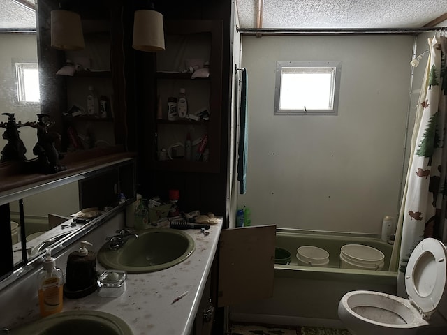 full bath with vanity, a textured ceiling, toilet, and shower / bath combo with shower curtain