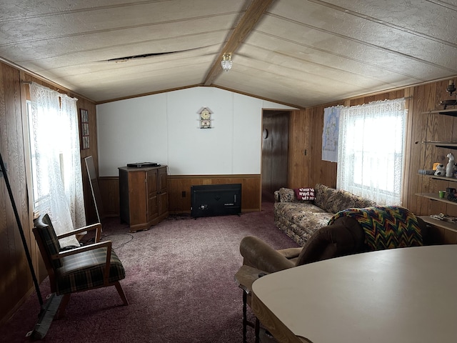 carpeted living area featuring wainscoting, wood walls, and lofted ceiling with beams