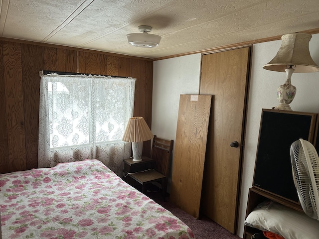 bedroom featuring wood walls