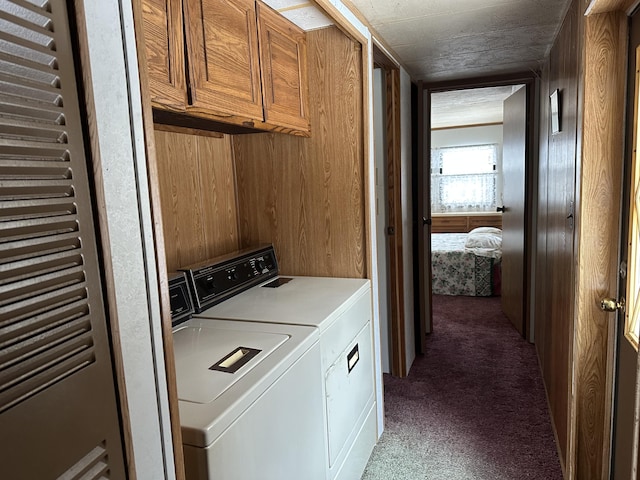 laundry room featuring carpet floors, cabinet space, and independent washer and dryer