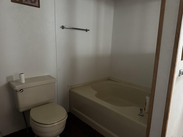 bathroom featuring a bath and toilet