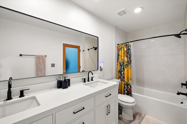 bathroom with shower / bath combo with shower curtain, visible vents, a sink, and double vanity