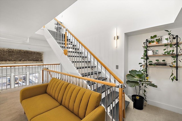 staircase featuring carpet and baseboards