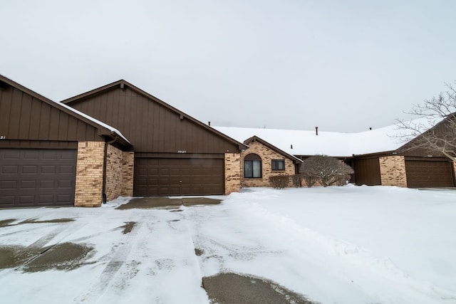 view of front facade featuring a garage and brick siding