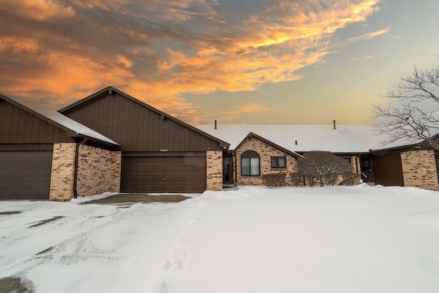 view of front of property featuring brick siding and an attached garage