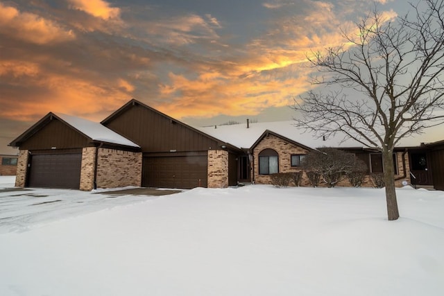 view of front of home with brick siding and an attached garage