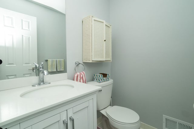 bathroom featuring toilet, visible vents, and vanity
