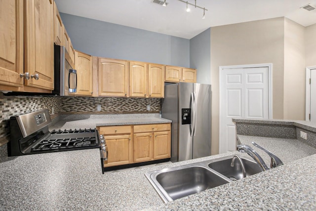 kitchen with visible vents, decorative backsplash, stainless steel appliances, light countertops, and a sink