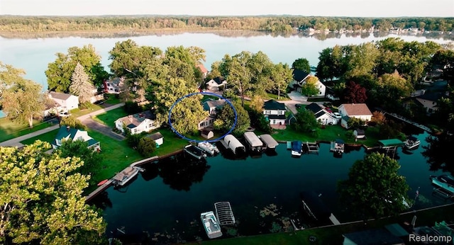 birds eye view of property featuring a water view and a residential view