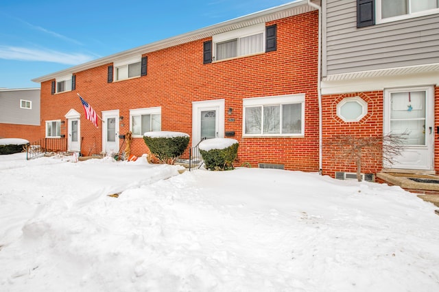 townhome / multi-family property featuring brick siding