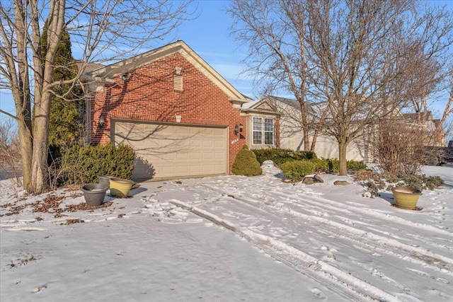 view of front of house featuring brick siding and an attached garage