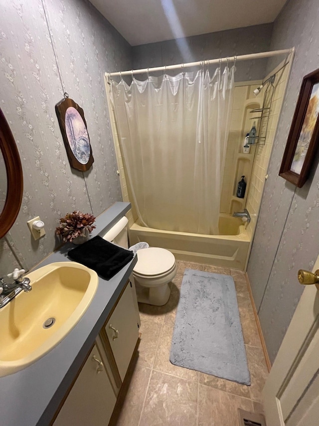 bathroom with toilet, shower / bath combo, and vanity