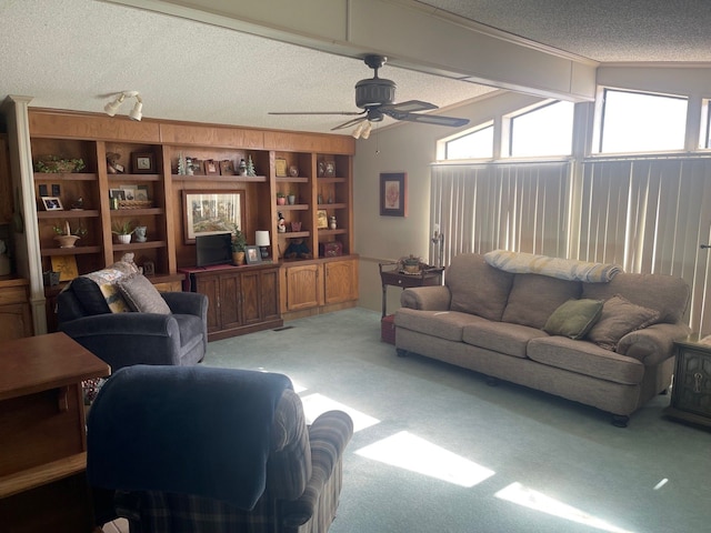 living area featuring light carpet, vaulted ceiling with beams, ceiling fan, and a textured ceiling