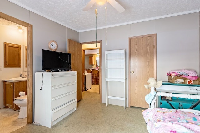 bedroom with light carpet, ensuite bath, crown molding, a textured ceiling, and a sink