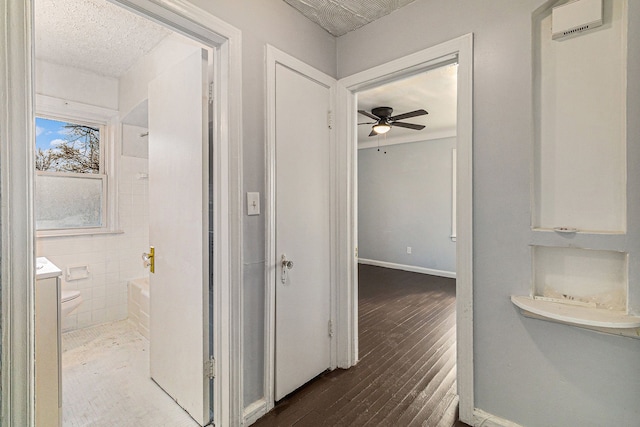 full bath with baseboards, a ceiling fan, toilet, wood finished floors, and vanity