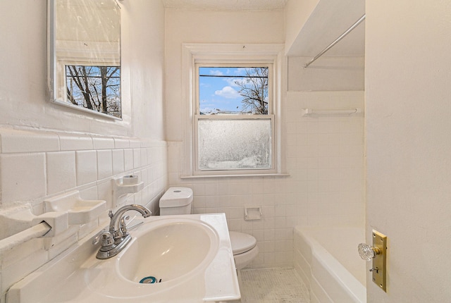 full bathroom with a wainscoted wall, vanity, toilet, and tile walls