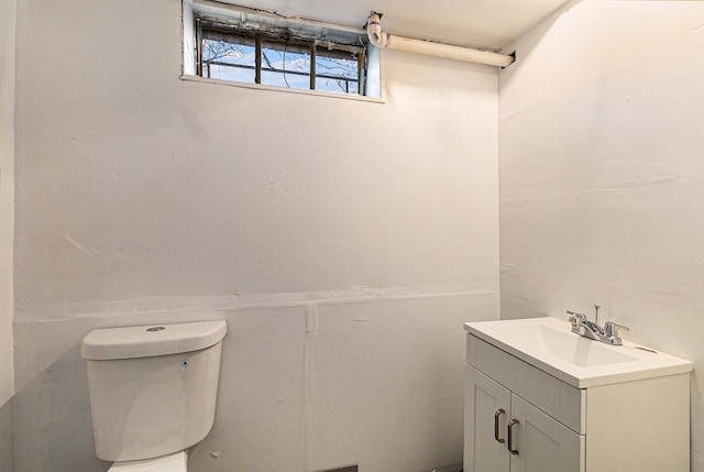 bathroom featuring toilet and vanity