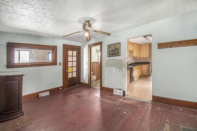 interior space with baseboards, visible vents, and dark wood finished floors