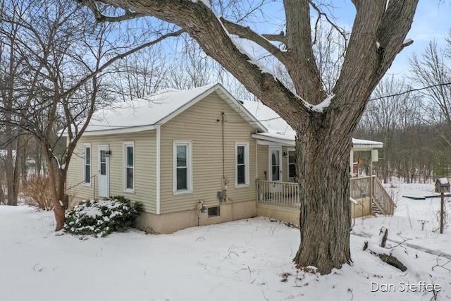 view of snow covered exterior featuring a garage