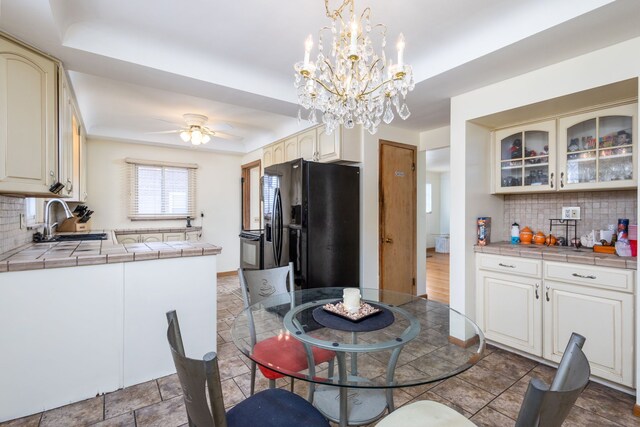 dining room featuring ceiling fan and baseboards