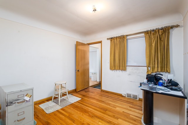 office featuring light wood-type flooring, baseboards, and visible vents