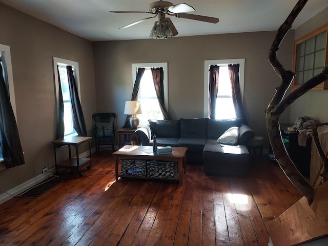 living room featuring ceiling fan, dark wood-style flooring, a wealth of natural light, and baseboards