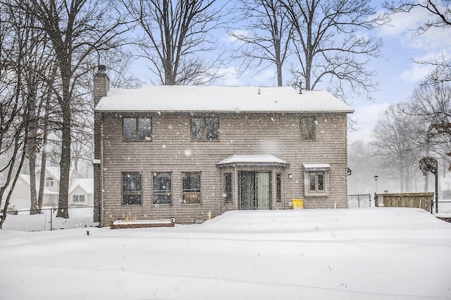 colonial house featuring a chimney