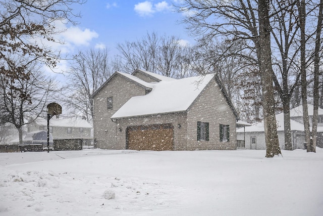 view of snowy exterior with a garage