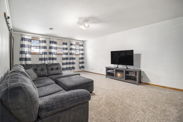 carpeted living area featuring visible vents, baseboards, and a textured ceiling