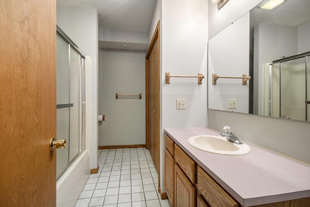 bathroom featuring tile patterned flooring, vanity, baseboards, and bath / shower combo with glass door