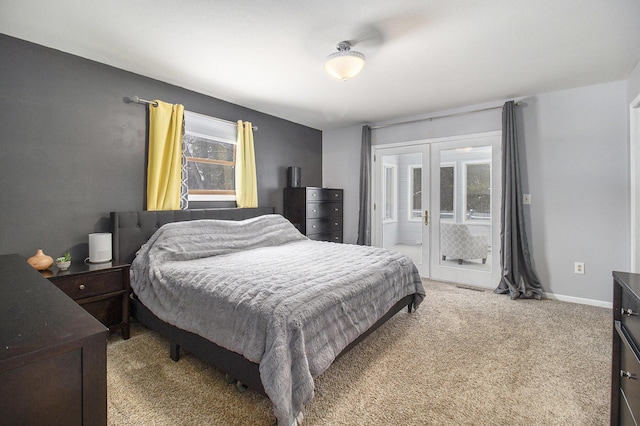 bedroom with light carpet, access to outside, french doors, and baseboards