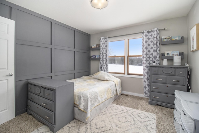 bedroom with baseboards and a decorative wall