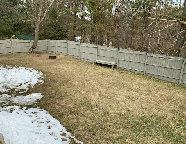 snowy yard featuring fence