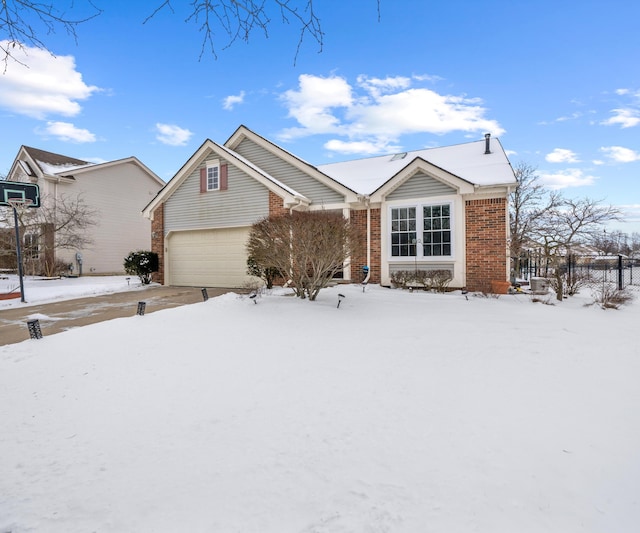 view of front of home featuring driveway, brick siding, and an attached garage