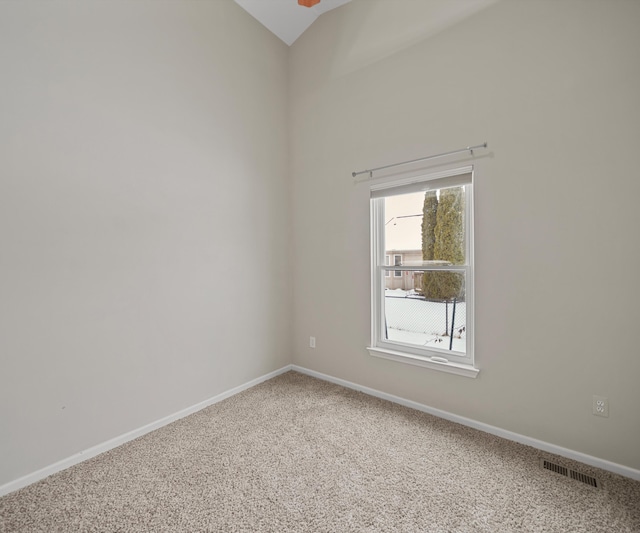 carpeted empty room with visible vents and baseboards