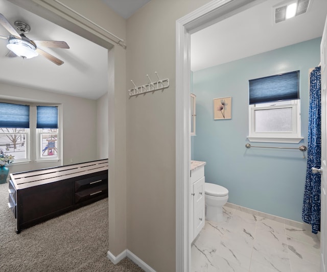 full bathroom featuring baseboards, toilet, ceiling fan, marble finish floor, and vanity