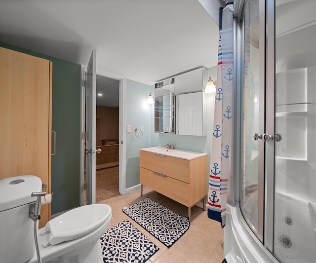 bathroom with tile patterned flooring, baseboards, vanity, and toilet