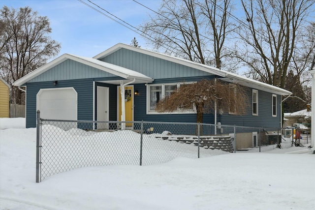 view of front of home with a garage and fence