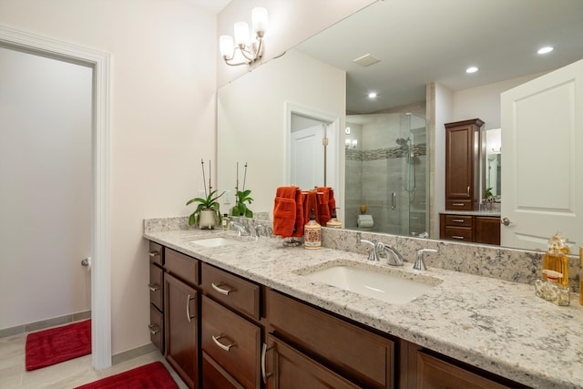 bathroom featuring a stall shower, a sink, recessed lighting, and double vanity