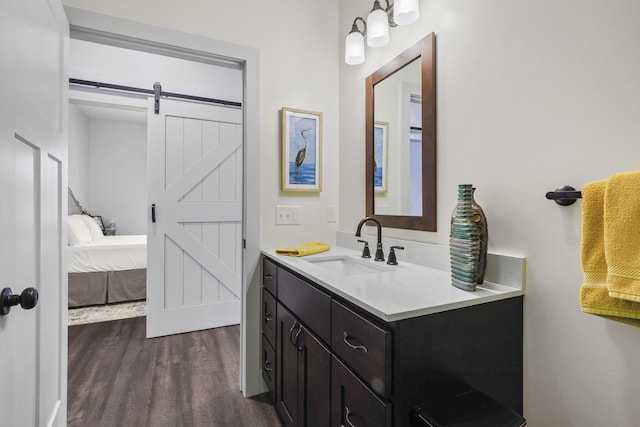 bathroom with ensuite bathroom, wood finished floors, and vanity