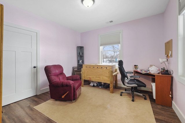 office featuring wood finished floors, visible vents, and baseboards