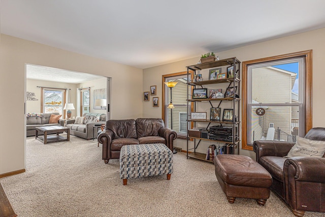 living room featuring carpet flooring and baseboards