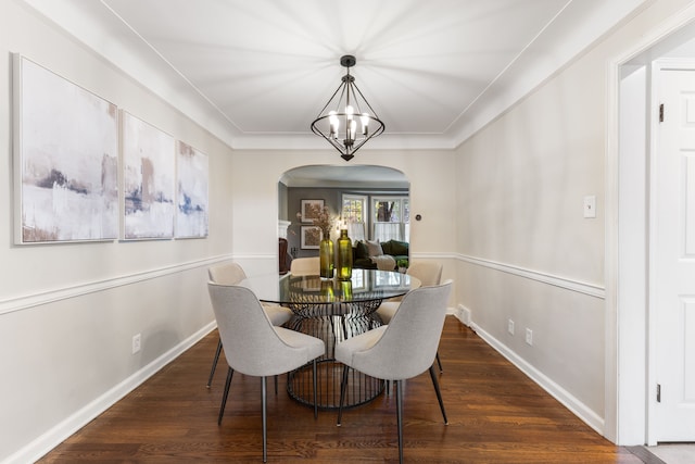 dining room with arched walkways, baseboards, dark wood finished floors, and a notable chandelier