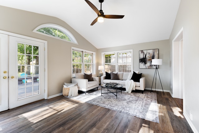 living area featuring high vaulted ceiling, wood finished floors, a wealth of natural light, and baseboards