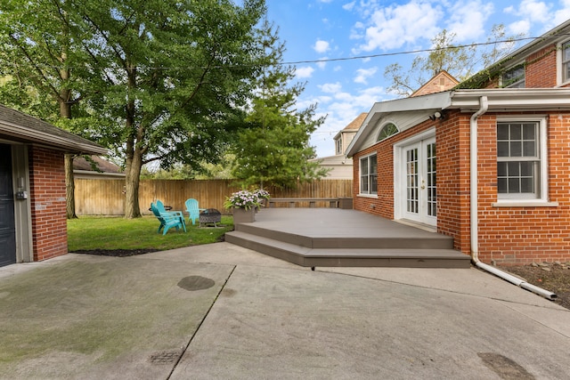 view of patio featuring french doors, a fenced backyard, and a wooden deck