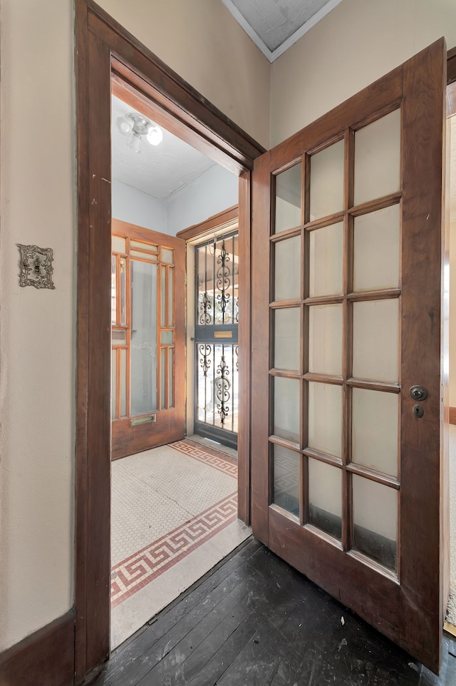 hall with dark wood-style floors and crown molding