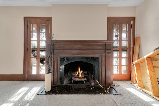 interior details with ornamental molding, carpet flooring, and a fireplace