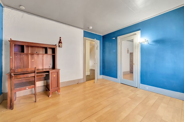 unfurnished bedroom featuring light wood-type flooring and baseboards